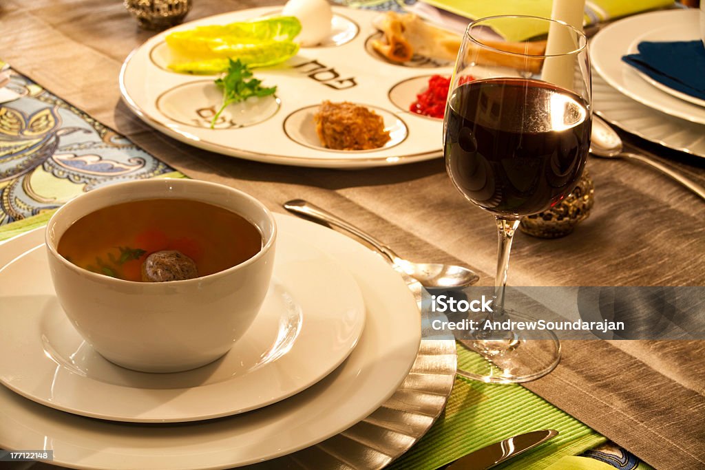Passover Table Setting "Seder plate, glass of wine and a bowl of Mazto ball soup provide the setting at a passover table." Seder Stock Photo