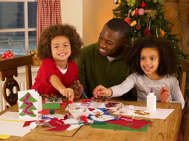 istock Father and his two children making Christmas cards 177122335