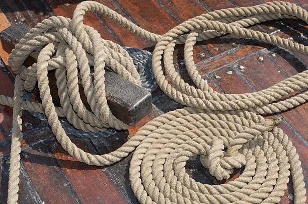 some ropes lying on the deck of a tallship