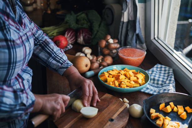 istock Cutting Onions on Wooden Board 1771244006