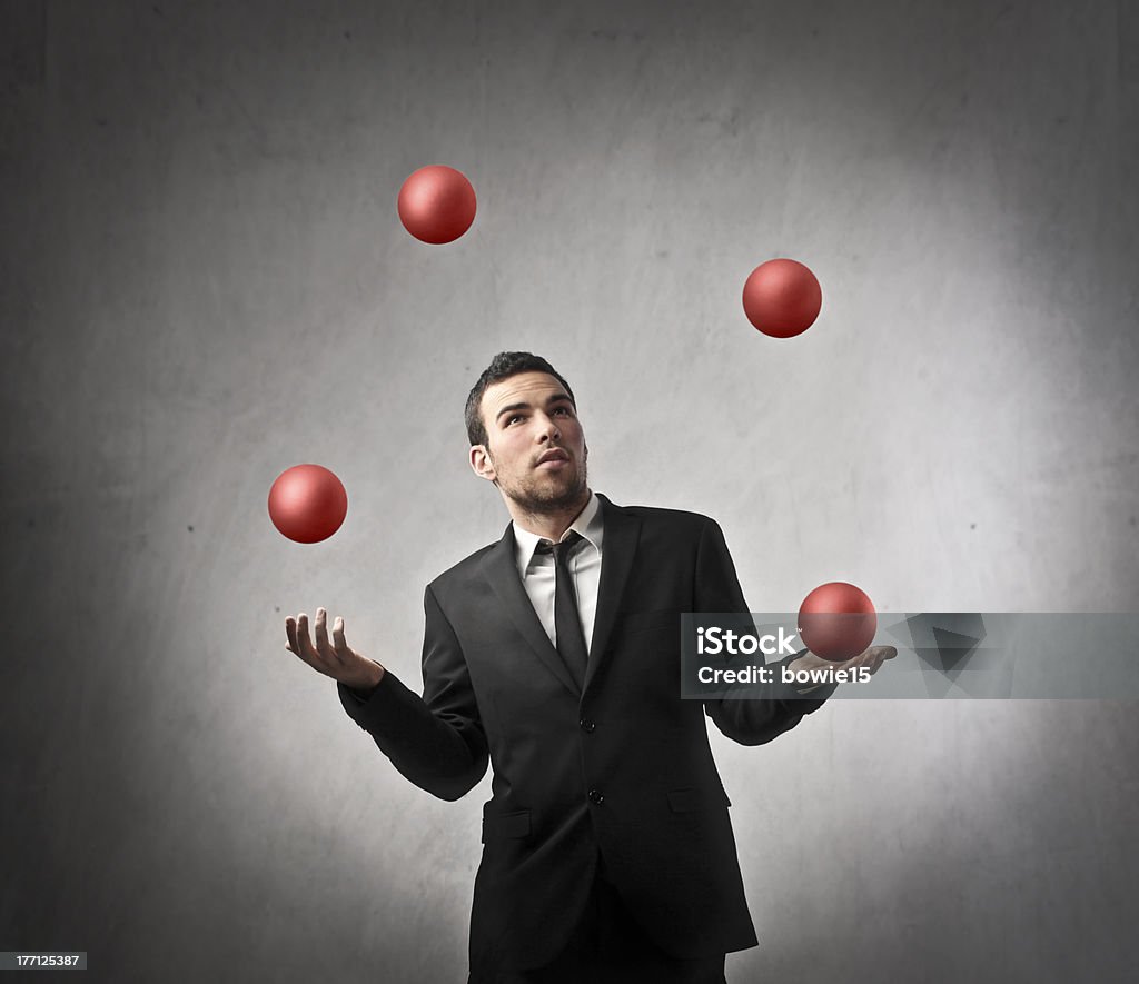 Ability in business Young businessman juggling with some spheres Juggling Stock Photo