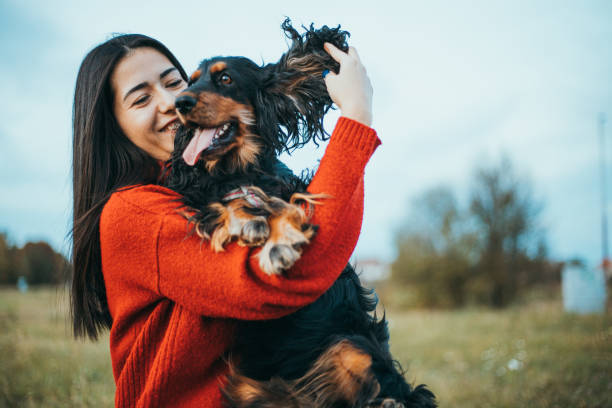 istock woman playing with dog 1771254945