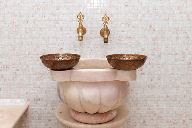 faucets and  copper bowl in turkish hamam stock photo