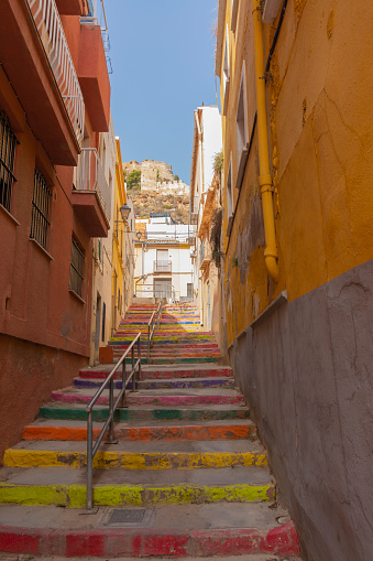 Sagunto, Valencia, Spain. August 30th, 2022 - One of the streets of the old town of Sagunto, with painted steps, to go up to the Roman castle, with Iberian, Roman, Goth, Arab remains