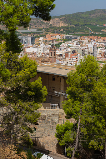 Sagunto, Valencia, Spain. August 30th, 2022 - View of the city, the old town, the church of Holy Mary, from a viewpoint on the roman theatre