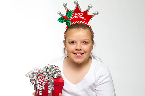 istock Girl with Christmas Headband holding gift 177126670
