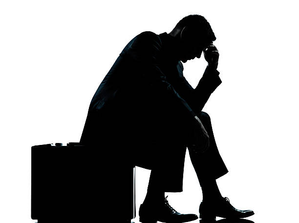 istock one business man sitting on suitcase tired despair silhouette 177126882