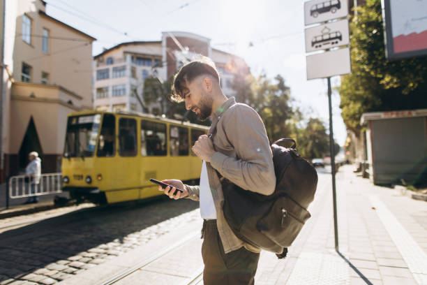 istock The handsome man using smartphone while waiting at the bus station 1771273544