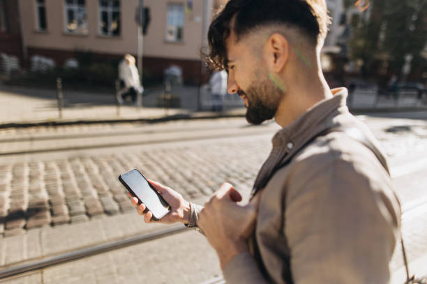 istock The handsome man using smartphone while waiting at the bus station 1771274063