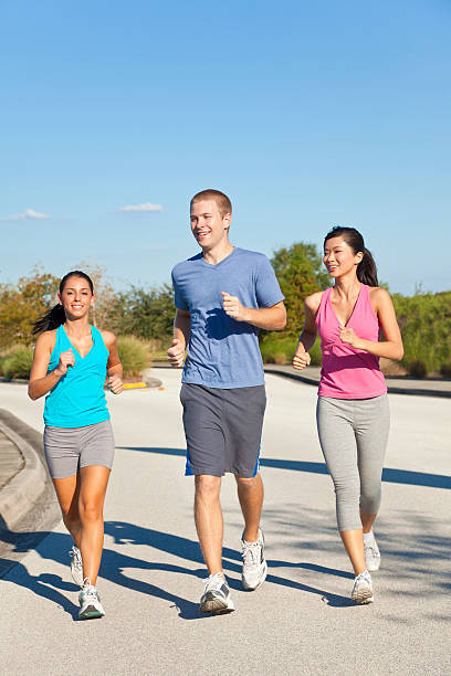 istock Three Interracial Young Adult Friends Running Jogging 177129119