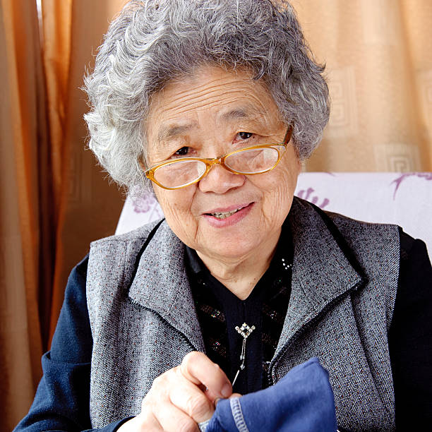 istock sewing grandmother with glasses 177129220