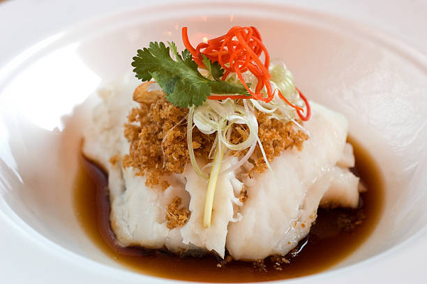 Imperial fillet of cod garnished with garlic floss, scallion, cilantro and chilli