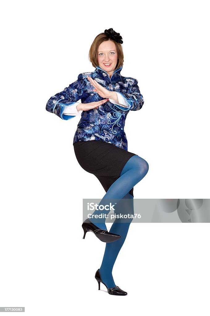 Woman taking defensive position. Caucasian woman taking defensive position in Chinese traditional clothing. Isolated on white. Activity Stock Photo