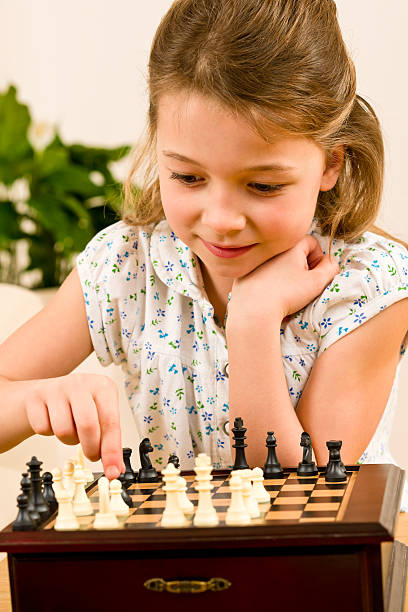 istock Young girl play chess cute smile 177130198