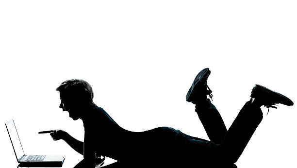 istock one young teenager boy  girl silhouette computer computing lapto 177130404