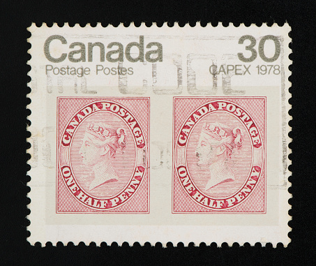 Canadian postage stamp on black background. Studio Shot. 