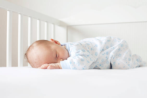istock newborn lying on his tummy in crib 177131143
