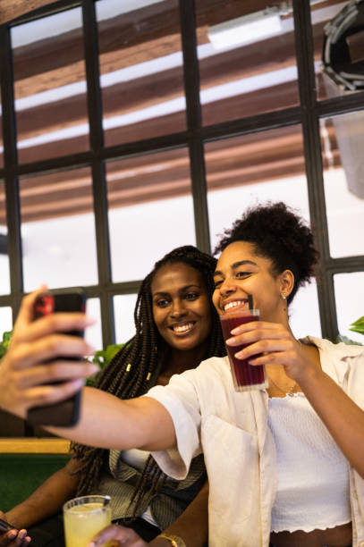 istock Cute friends taking a selfie drinking cocktails in a bar 1771321768