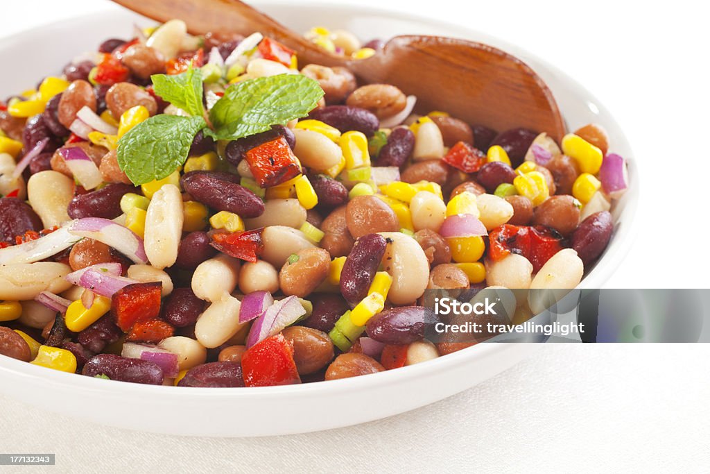 Three Bean Salad "Three bean salad with sweetcorn, roasted red peppers and red onion in a vinaigrette dresing. Focus on foreground." Bean Stock Photo