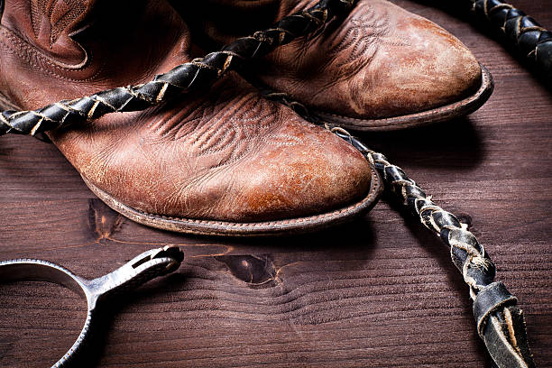 istock Cowboy boots whip and spurs on wood 177132474