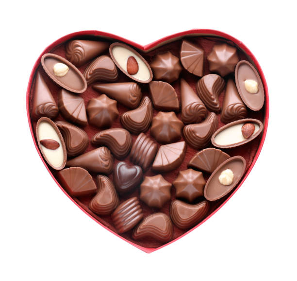 istock Heart shaped box with delicious chocolate candies on white background, top view 1771326630