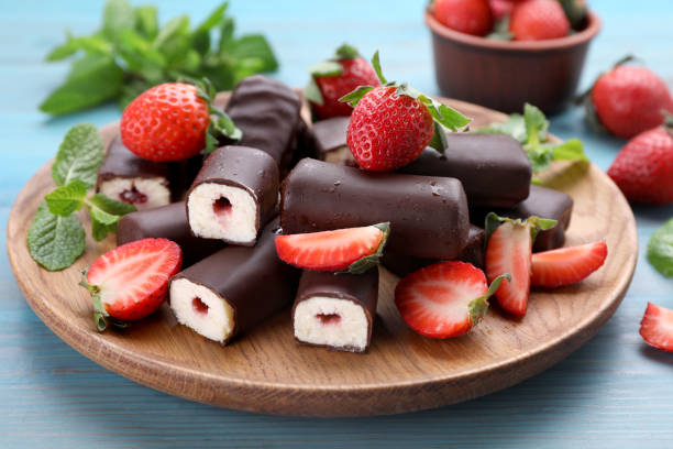 istock Delicious glazed curd snacks with fresh strawberries and mint on light blue wooden table 1771327280
