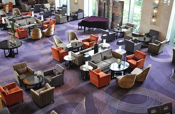 Luxury hotel bar lounge with dark colored carpet.
