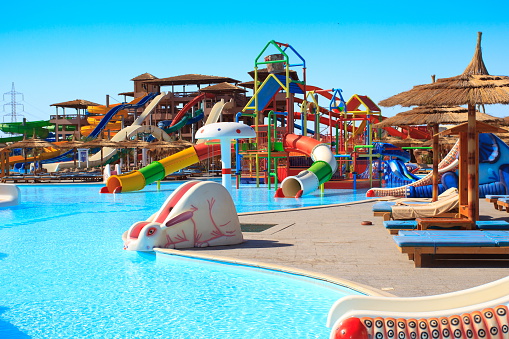 \tA background of a water park and a swimming pool with bright colors