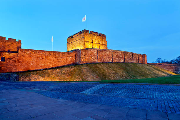 Exterior view of Carlisle Castle lit up at night stock photo