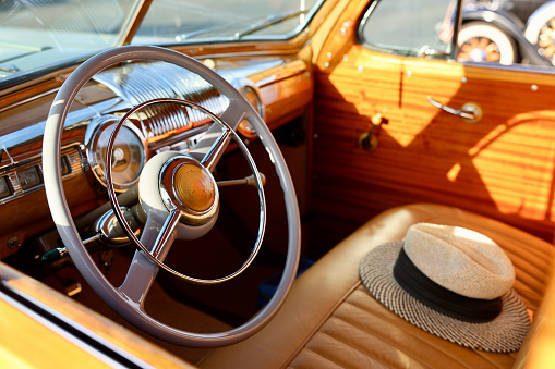 Mans Panama hat sitting on the front seat of a vintage car