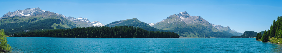 Mountain landscape, lake and mountain range, large panorama. Panoramic view of beautiful mountain landscape in Alps with Silsersee lake, concept of an ideal resting place. .