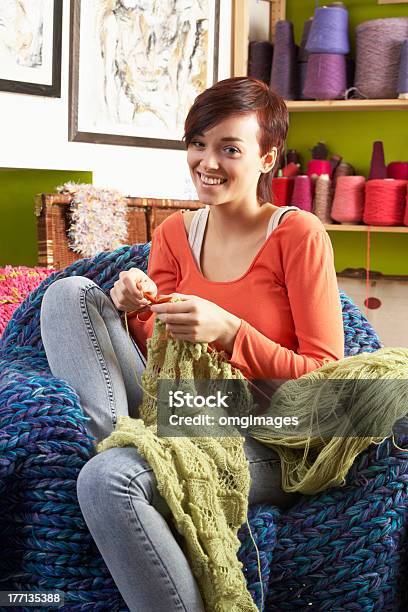 Jovem Mulher Sentada Na Cadeira De Tricô - Fotografias de stock e mais imagens de Cachecol - Cachecol, Mulheres, Tricotar