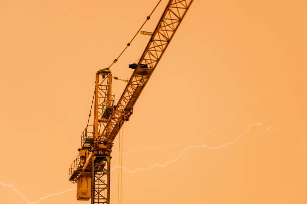 Crane struck by lightning, powerful thunderbolt. Weather risk assessments for the construction industry and built environment