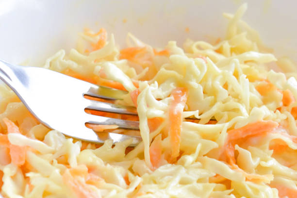 istock Coleslaw salad with carrot and cabbage on a white bowl. 1771364839
