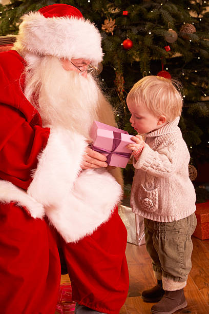 istock Santa Claus Giving Gift To Toddler 177136548