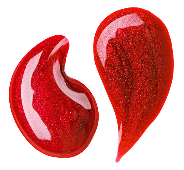 Red nail polish (enamel) drops sample, isolated on white stock photo