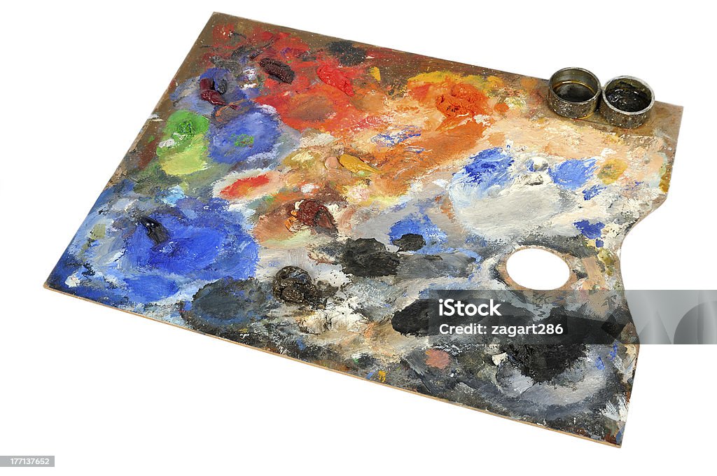 Artistic palette Artistic palette covered with colors on white background Art Stock Photo