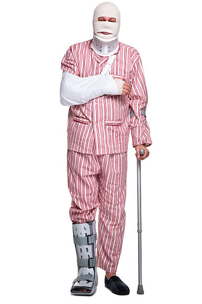 Injured man walking on crutches Photo of an injured man walking on crutches, isolated on a white background. man with arm sling stock pictures, royalty-free photos & images