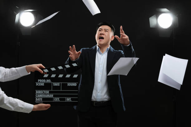 istock Emotional asian actor performing role while second assistant camera holding clapperboard on stage. Film industry 1771393988