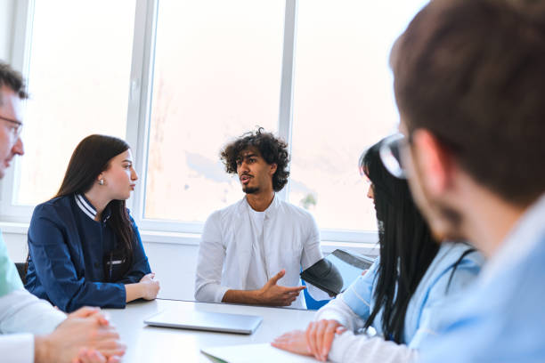 istock A young African American doctor, utilizing a smart tablet, confidently presents his work and patient care plan to fellow physicians in a modern hospital, fostering collaboration and advanced healthcare management 1771397224