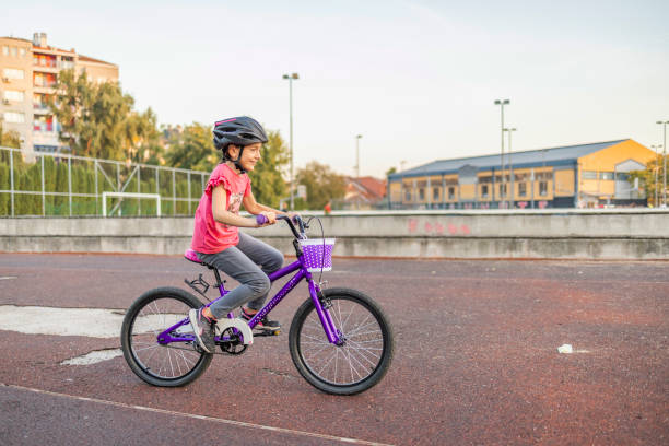 istock Little girl learns to drive a bicycle. First ride alone, without help. 1771411793