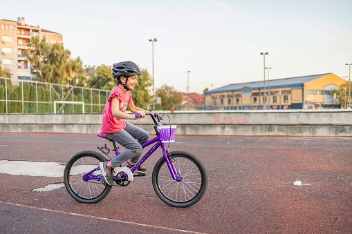 Little girl learns to drive a bicycle. First ride alone, without help.