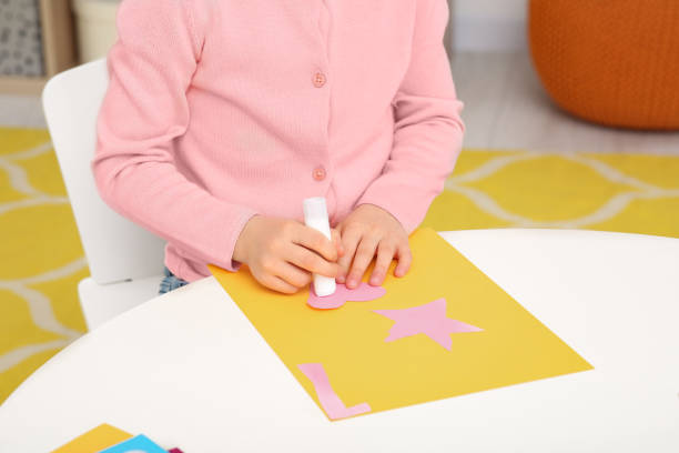 istock Girl using glue stick at desk in room, closeup. Home workplace 1771412298