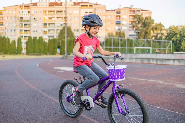 istock Little girl learns to drive a bicycle. First ride alone, without help. 1771412323