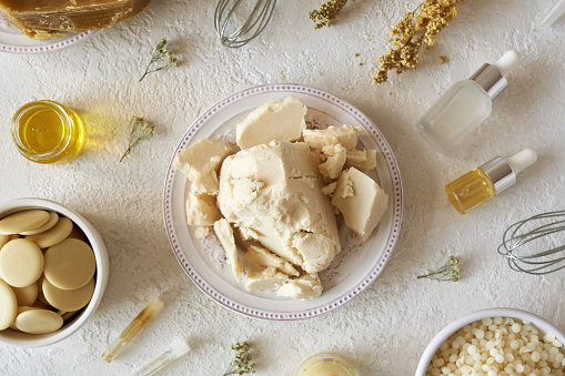 Shea butter with other ingredients for homemade cosmetics - cocoa butter, beeswax, herbs and essential oils