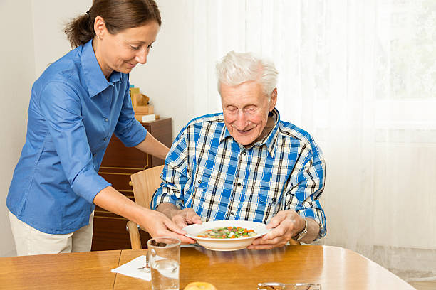 istock Nurse giving senior man lunch 177142778