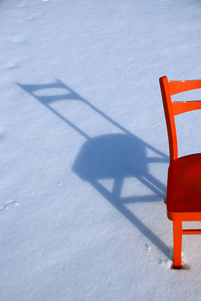 istock orange chair shadow on snow 177144648