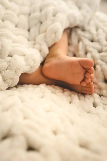 Photo of New Born Baby Feet on White Blanket