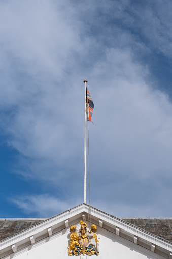 A torn British flag Union Jack on top of Custom House in Exeter, October 2023
