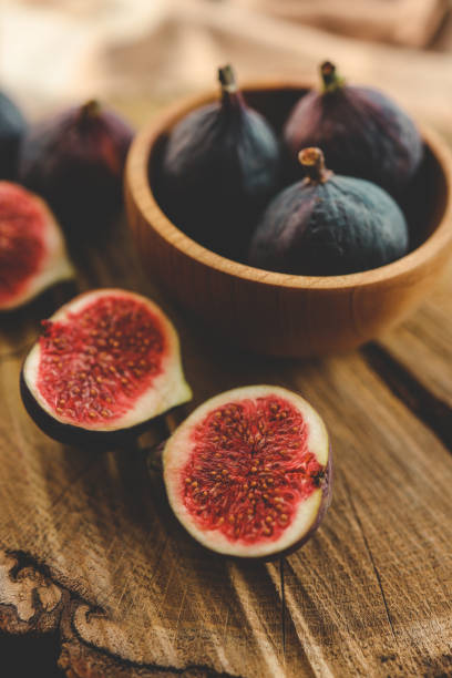 istock A few figs in a bowl on an old wooden background. 1771453741